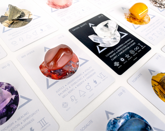 Close-up of tarot cards with various symbols and designs on a white surface.