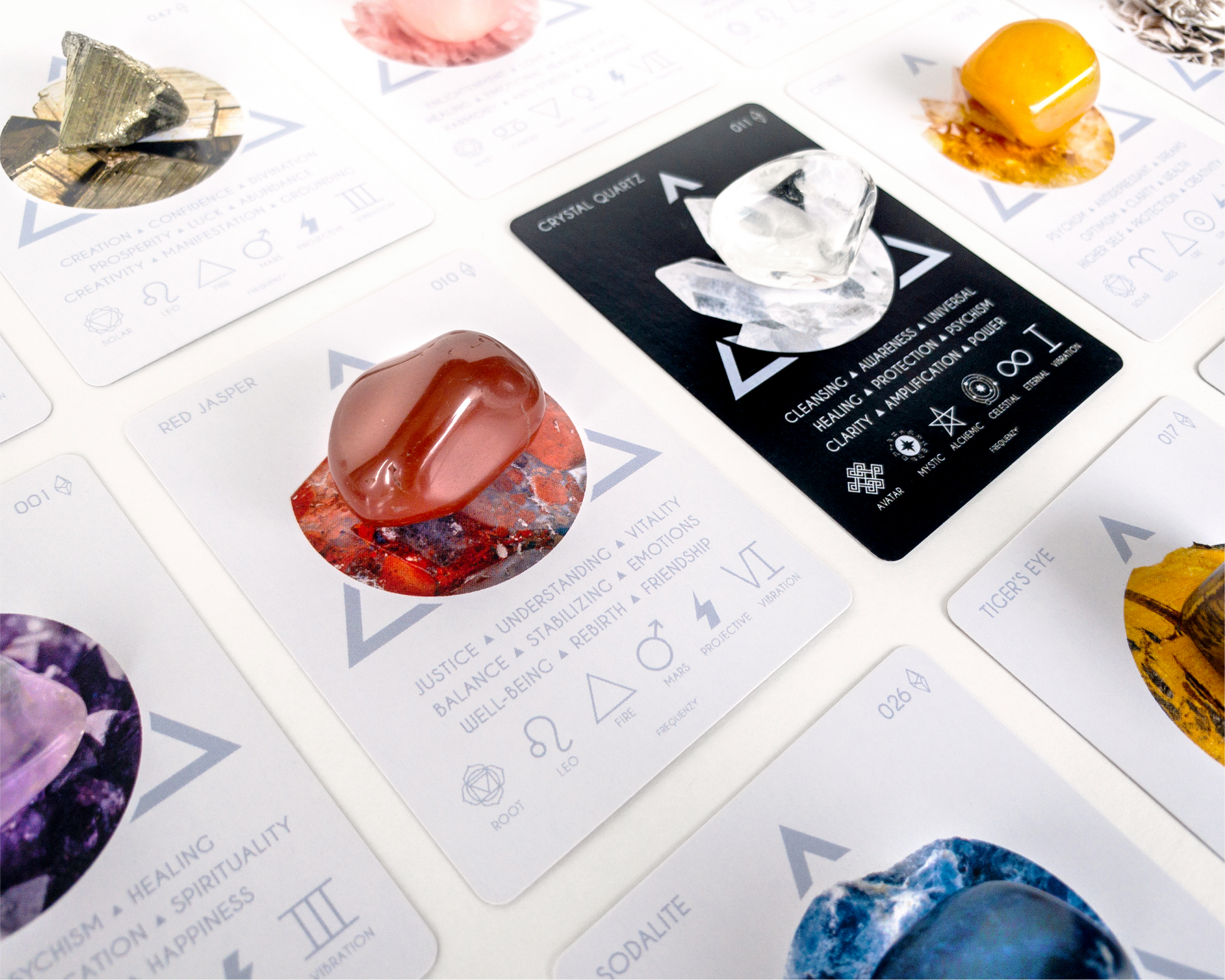 Close-up of tarot cards with various symbols and designs on a white surface.