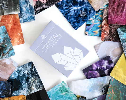 Collection of colorful crystal cards with a 'Crystal' box on a white surface